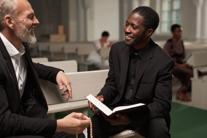 Pastor Advising Senior Man in Church
